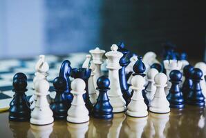 Classic chess game in progress with wooden chess pieces on a board, symbolizing strategy, intelligence, and competition photo