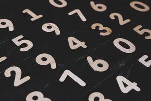 different numbers figure on black texture photo