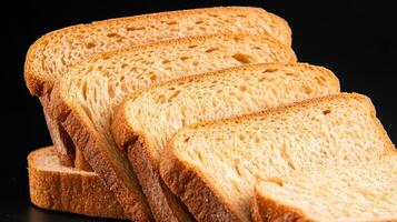 Freshly sliced bread arranged neatly on a dark background, showcasing texture and color. photo