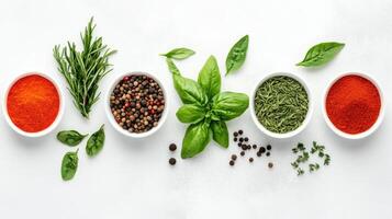 An array of colorful spices and fresh herbs on a white background. photo