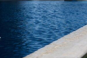 Tranquil water ripples create calming reflections in a serene pool under a clear sky photo
