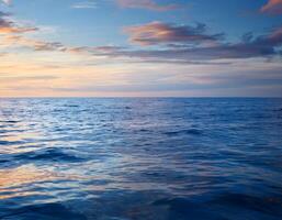 Golden Hour Over the Ocean with Peaceful Waves and Reflections photo