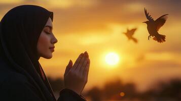 Woman Praying and Releasing Birds into Nature . A Symbol of Hope and Freedom photo