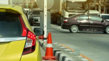 Rear side of yellow car with turn on brake light. Stop on the road waiting for traffic condition. with other car passthong in the junction. Many car stop on opposite road in the city. photo