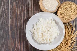 Fresh Cooked White Rice on Wooden Table with Raw Ingredients photo