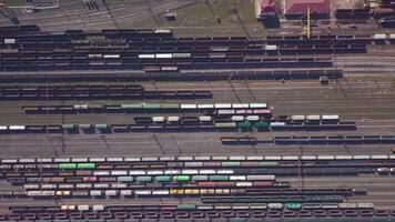 Aerial view of Railway sorting station and A lot of wagons at a railway. Drone flies over railway tracks. 4k quality video