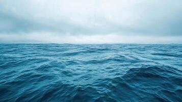 Distant View of Rippling Ocean Waters Under Cloudy Sky photo