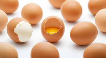 Closeup of Broken and Whole Chicken Eggs on White Background A Culinary Still Life Photography photo