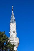 Mosque Minaret on a background of blue sky in Turkey photo
