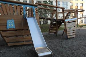 Metal slide on the playground. Modern courtyard photo
