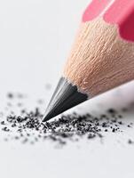 Close view of a pencil eraser removing mistakes on paper, showcasing remnants of erased graphite and textures photo