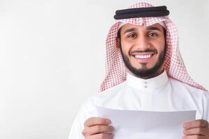 Smiling Arab male salesperson presents contract in professional setting with white background photo
