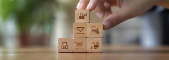 Hand Arranging Wooden Cubes with Icons Representing Data Security and Privacy photo