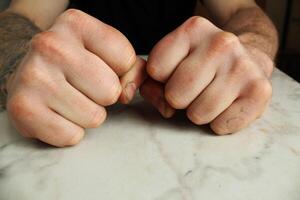 fists on the table. The concept of domestic violence photo