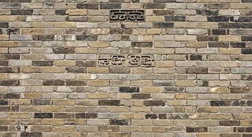 A brick wall with a clock on it photo