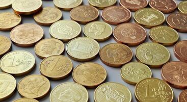 A Collection of Diverse Coins From Around the World Arranged in a Visually Appealing Pattern photo
