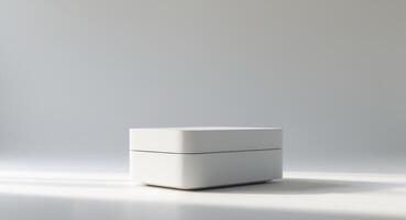 A white box sitting on a table in front of a wall photo