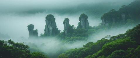 Majestic rock formations emerging through fog with lush greenery in the background. photo