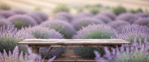 Wooden Table Surrounded by Beautiful Lavender Field in Soft Light. photo