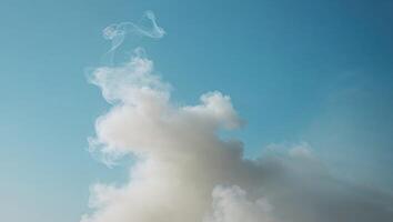 Blue sky with a lot of smoke in the background photo