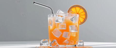 Refreshing orange drink with ice cubes and a straw garnished with an orange slice Perfect for summer celebrations. photo