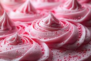 Pink frosting swirls with pink sprinkles on a cake photo