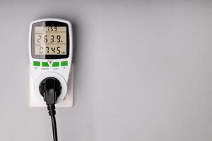 Energy Meter Measuring Power Consumption from Plugged in Device photo