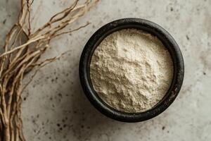 Bowl of Ashwagandha Powder with Roots Ideal for Herbal Remedies photo