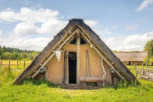 Celtic house with straw thatched roof at Celtic open air museum in Nasavrky Czech republic photo