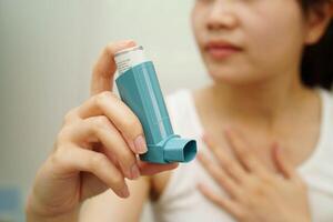 Asthma and chronic obstructive pulmonary disease COPD, Asian teenage using metered dose inh photo