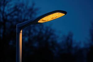 A street light with a yellow light shining on it photo