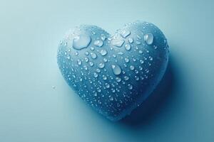 A blue heart shaped object with water droplets on it photo
