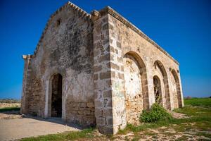 An old Orthodox church in ruins stands by the sea on the northern coast of Cyprus. The image reflects history, faith, and the passage of time in a coastal Mediterranean setting. High quality photo