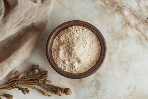 Bowl of Ashwagandha Powder with Roots for Health and Wellness Use photo