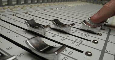 A person is touching a mixing board with a knob video
