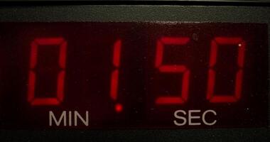 A digital clock with red numbers on it video