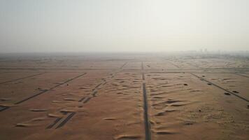 An aerial view of a desert with sand and buildings video