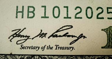 A close up of a one hundred dollar bill with the signature of henry m buchanan video