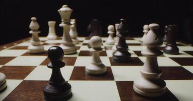A chessboard with pieces set up for a game video