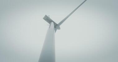A wind turbine with a gloomy sky background video