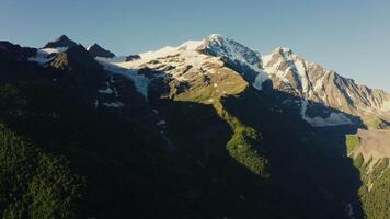 Aerial view of mountain range with snow capped peaks video