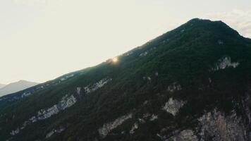 A mountain with a sun shining on it video