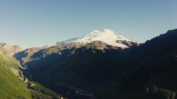 A panoramic view mountain with a snow capped peak in the distance video