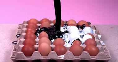 black and white paint is poured into an eggs tray video
