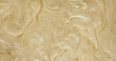 The fine texture of yellow sand captured up close, creating a textured background video