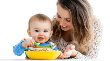 Smiling baby enjoys a meal while sitting at a table with mother in a bright indoor setting during the day png