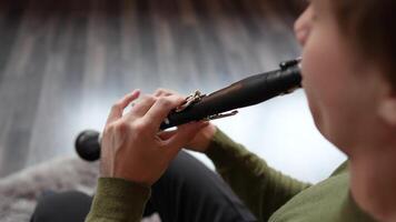 Musician hands playing and mastering clarinet technique, press keys for sound extraction, practicing video