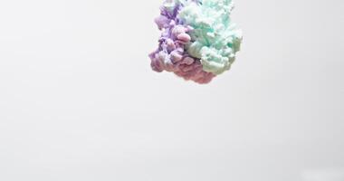 A rainbow colored paint drop in the water video