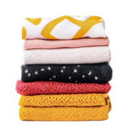 Stack of colorful folded sweaters in various textures and patterns png