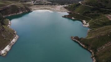 A lake nestled in the mountains from above. photo